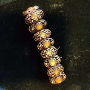 Brass tone bracelet with yellow stones